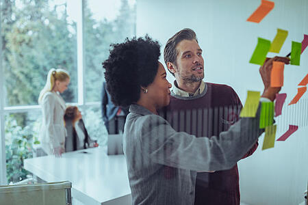 Couple looking at post it notes